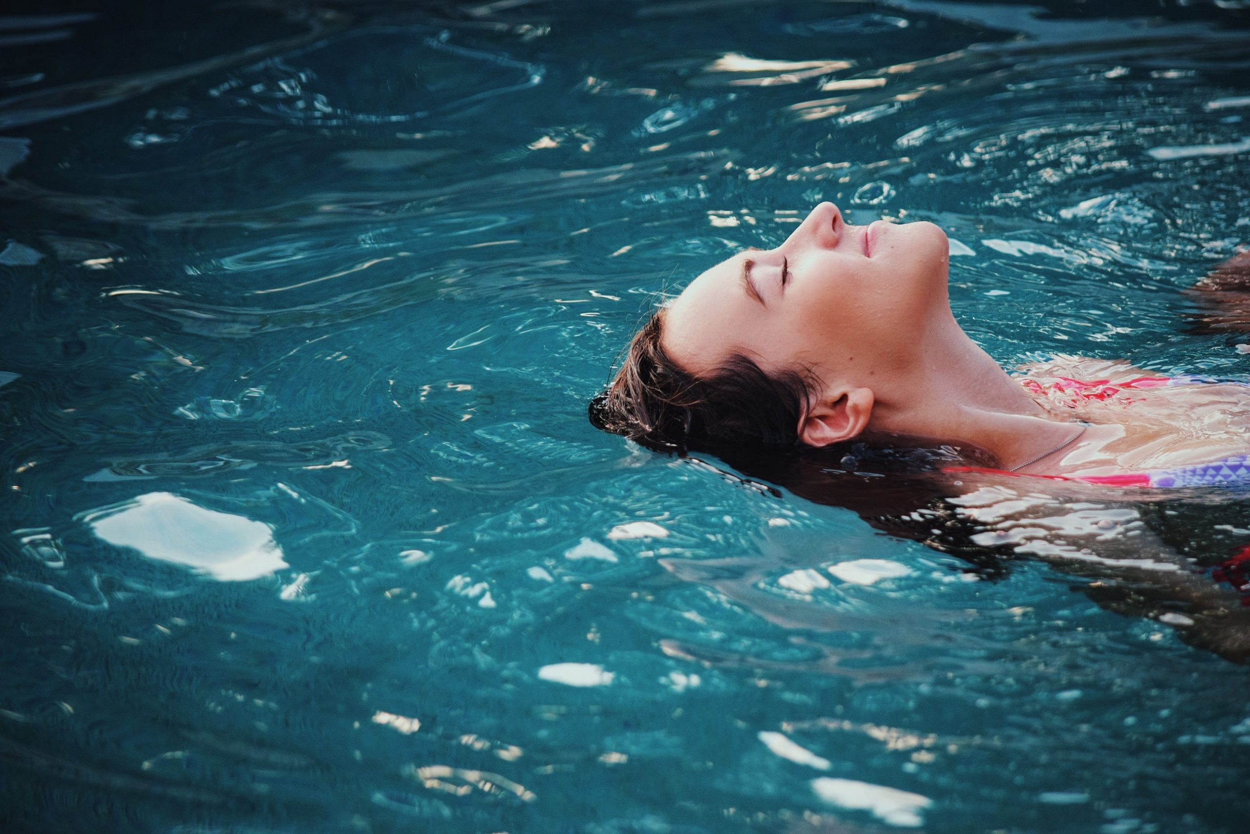 uma mulher em uma piscina em estado de relaxamento